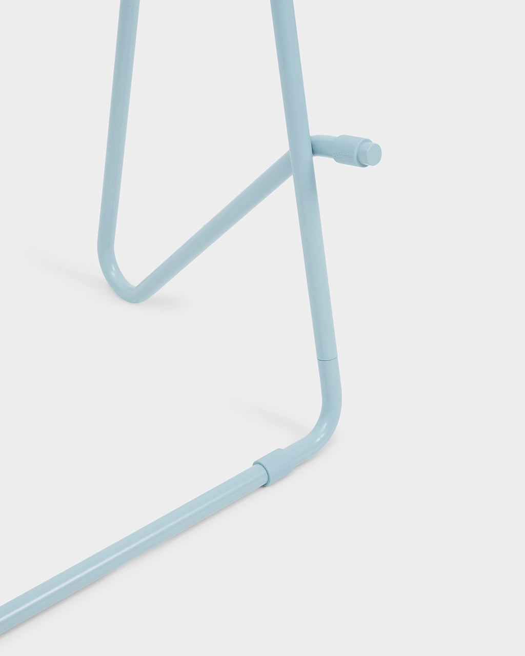 Close-up studio detail of Bloom Stands Low in Powder Blue, showing the tubular leg joint and connector hardware