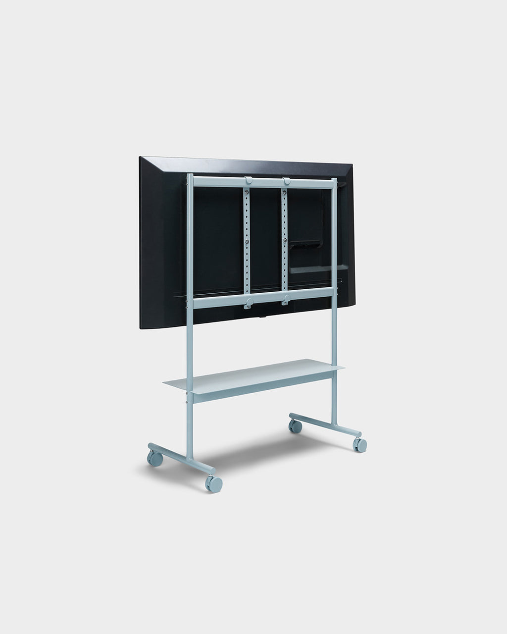 Rear view of Rover stand in Powder Blue with mounted TV, shelf and locking wheels, studio packshot on light grey