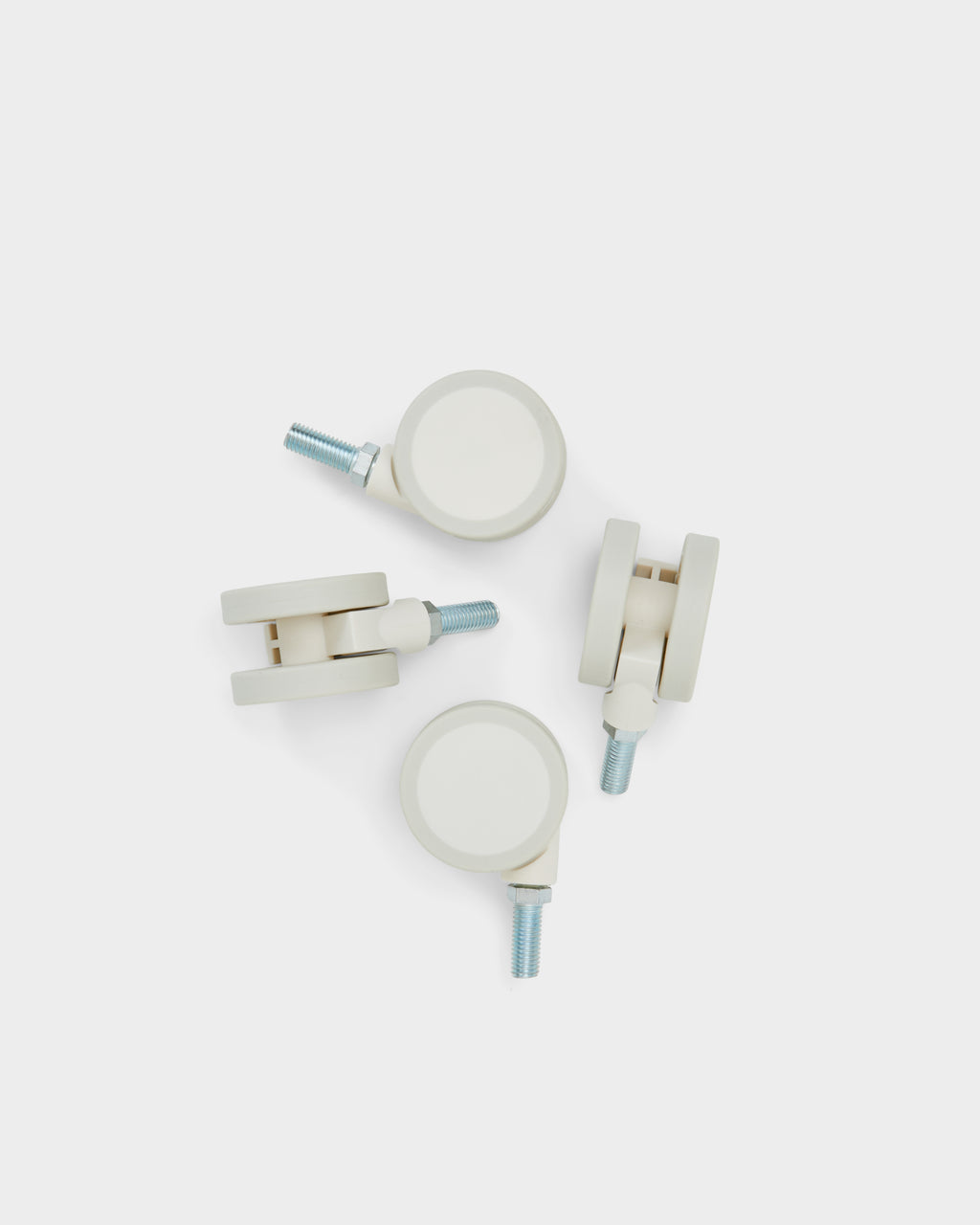 Four Wheels in Pearl casters with threaded steel stems arranged on a light studio background